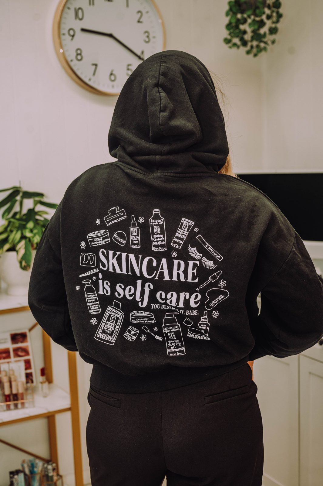 Black hoodie printed with Skincare is self care, you deserve it babe